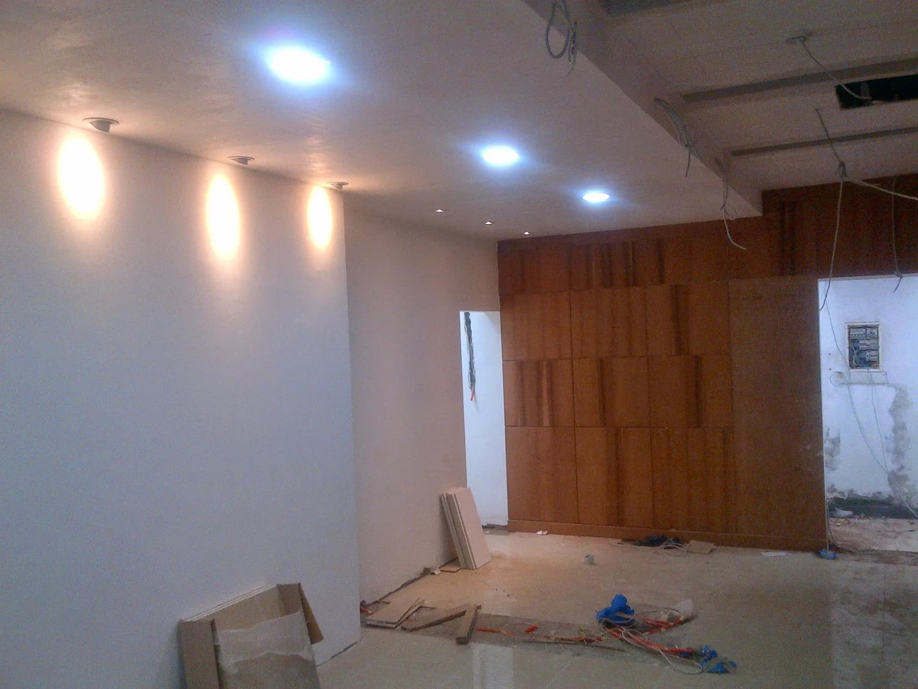 Aménagement intérieur en cours : murs peints, spots encastrés et cloison en placage bois